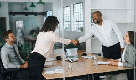 man and woman in office shaking hands